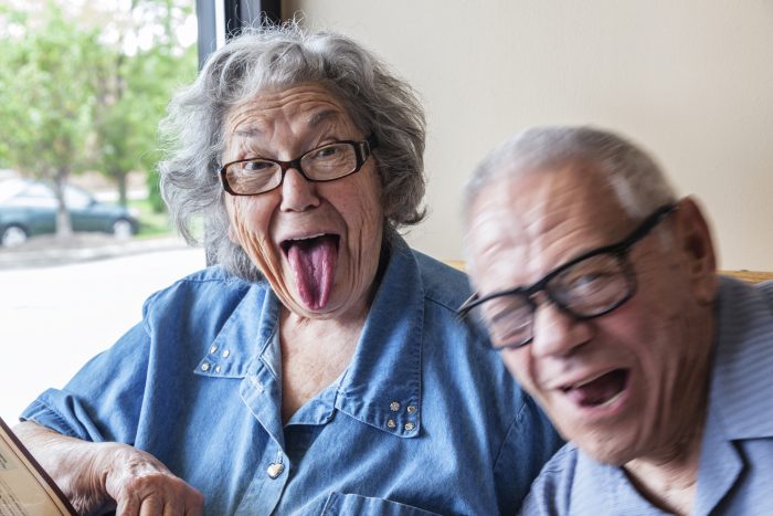 Grandpa Photo Bombing Grandma Making Funny Tongue Wagging Face