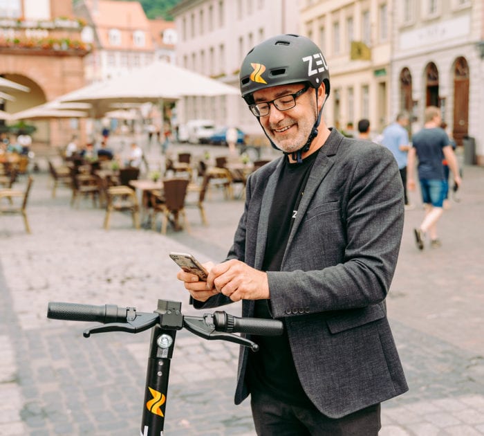Damian Young CEO Zeus Scooter downloads the app in Heidelberg